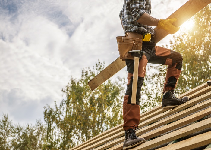 ABM General Construction roofer installs roof framing materials on a home, showcasing professional Residential Roofing Services.