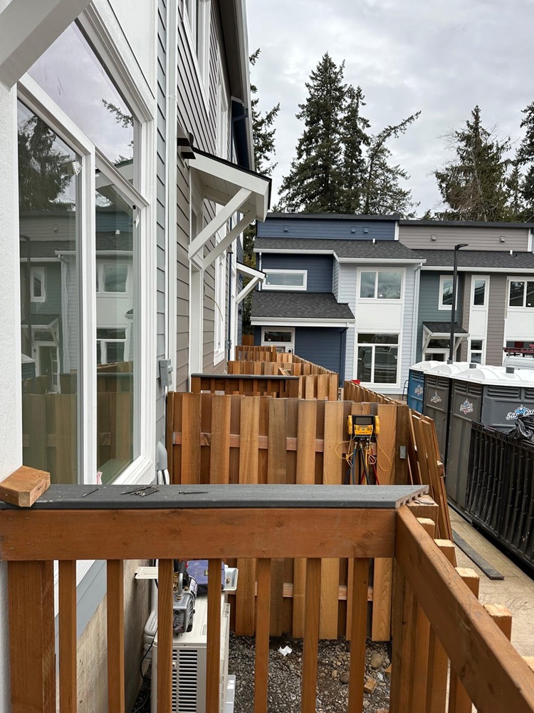 Siding Services by ABM General Construction, showing new exterior lap siding installation with fresh trim and window framing on a modern multi-unit home.